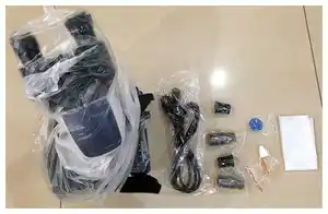 Microscope with all Accessories: power cord, two 10X eyepieces, 2 20X eyepieces, one blue filter, immersion oil, and dust bag